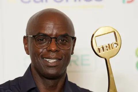 PA BBC Radio presenter Trevor Nelson with his trophy at the Television and Radio Industries Club (Tric) awards