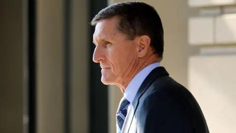  Michael Flynn, former national security advisor to President Donald Trump, wears a suit as he leaves a courthouse in 2017.
