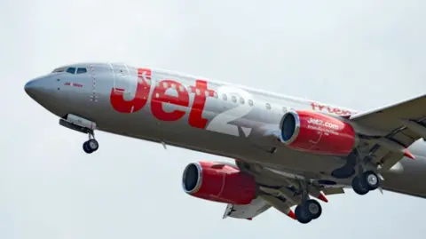 PA Media A red and silver Jet2 flights coming into land at Stansted Airport