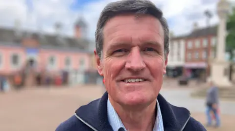 BBC Phil Jobson, a man with dark hair in a high street