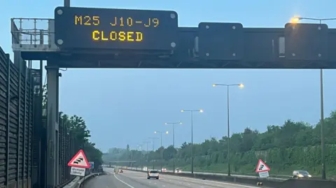 BBC Signs on the M25 warn of the closure ahead