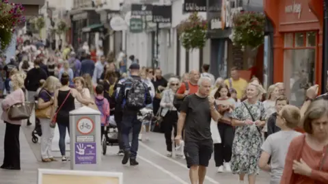 BBC People walking through town in Jersey