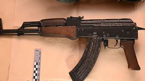 West Yorkshire Police An AK-47 gun, pictured against a beige background.