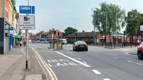 A view of a bus lane on Harlestone Road, Northampton. The road is a cross section with Weedon Road. 