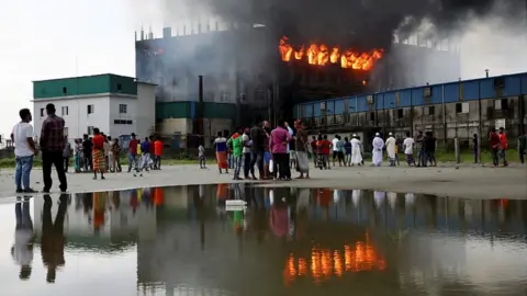 Reuters Flames rise at a Hashem Foods factory in Rupganj, Narayanganj district, on the outskirts of Dhaka, Bangladesh, July 9, 2021