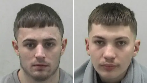 Mugshots of Thompson and Jahelezi. Thompson has stubble and short dark hair cut in a straight line at the fringe. Jahelezi has a very faint moustache and short brown hair.