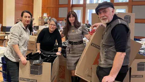 Gizem Salcigil White Gizem Salcigil White prepares donations