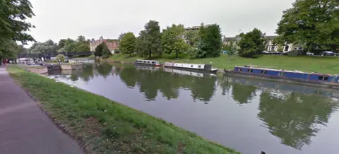 Google River with barges parked near bank