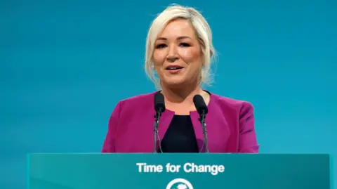 REUTERS/Clodagh Kilcoyne Michelle O'Neill delivers a code   astatine  the Sinn Fein ard fheis successful  Athlone, Ireland September 27, 2024. 