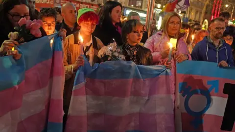 PA Media Members of the public attend a candle-lit vigil at the Spire on O'Connell Street in Dublin