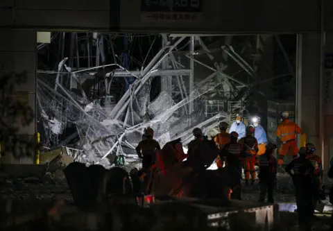 Reuters Rescue workers conduct a search and rescue operation at the damaged Aeon Mall shopping centre, where, according to local media, an explosion occurred after an earthquake with a preliminary magnitude of 7.1 struck Japan's southern Kumamoto prefecture, in Kashima Town, Kumamoto Prefecture, Japan, July 28, 2026.