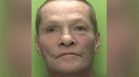 Nottinghamshire Police Police custody shot of Christopher Brealey, who has close cropped hair and is wearing a black t-shirt