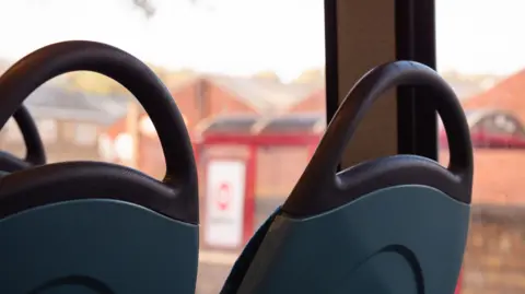 Getty Images A pair of empty seats on a bus.