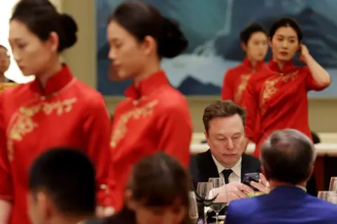 Getty Images Tesla CEO Elon Musk attends a state banquet hosted by Chinese President Xi Jinping at the Great Hall of the People on May 14, 2026 in Beijing, China.
