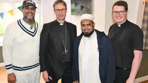 Clive Lawrence for Blackburn Diocese Rev Jordan McDermott (right) Abdul Alim Kheratkar (left), Bishop of Blackburn, Rt Rev Philip North and Mufti Ashfaq Qazi