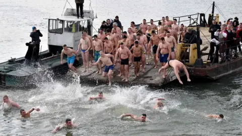 AFP Serbian Orthodox faithfuls jump into the cold water of the Sava river in Belgrade