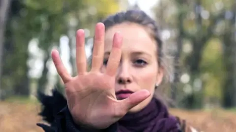 Getty Images Woman raising hand to stop