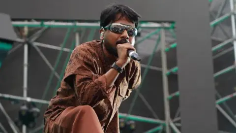 Shikriwal Rapper Shikriwal performs on stage at a music festival 