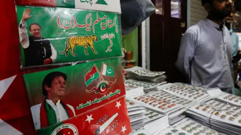 Reuters tickers badges, to be used for campaigns of political parties, on display for sale at a shop ahead of general elections in Karachi, Pakistan January 18, 2024.