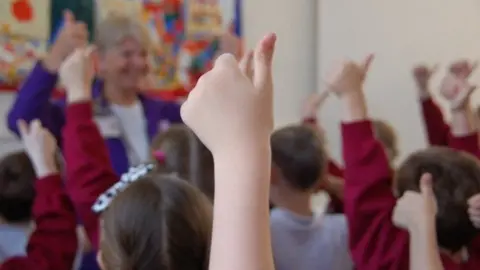 BBC Children with hands up