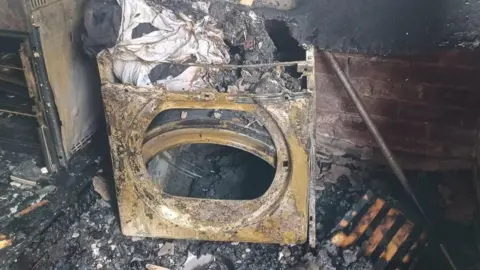 A damaged tumble dryer caused by fire