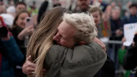 Jamie Laing hugs his wife Sophie Habboo at the finish line