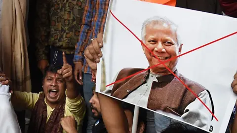 In Kolkata, India, on December 22, 2025, members of the Bharatiya Janata Party (BJP) and religious activists burn posters of Muhammad Yunus, Chief Adviser of Bangladesh's interim government, during a protest near the Deputy High Commission of Bangladesh in Kolkata. The demonstration follows reports of recent violence in Bangladesh after the killing of student leader Sharif Osman Hadi and the death of Hindu garment worker Dipu Chandra Das on December 18 amid allegations of blasphemy. (Photo by Debajyoti Chakraborty/NurPhoto via Getty Images)