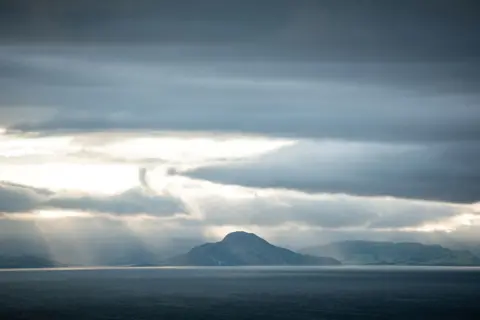 Ania Ciolacu  Swirling clouds with sun breaking through over the Isle of Arran, seen from Ayrshire

