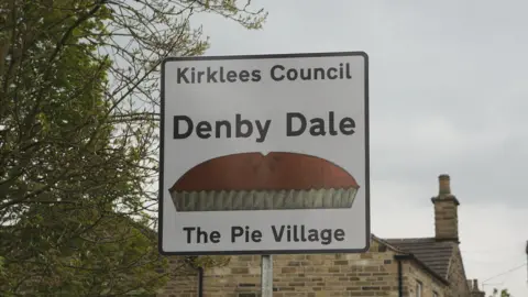 Ian S/Geograph Denby Dale, the Pie Village sign