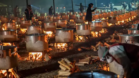 Brenton Geach/Getty Images Pots on flames for a meal being prepared by Nakhlistan Eid Cooking at Callies Rugby Field in Cape Town, South Africa - Wednesday 10 April 2024