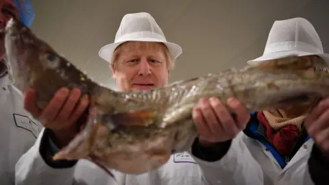 Getty Images UK Prime Minister Boris Johnson holding a large fish