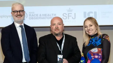 Avon & Wiltshire Mental Health Partnership NHS Trust Man stood with Alice Roberts on stage
