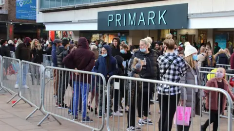 Getty Images Shoppers queue up outside Primark in Coventry