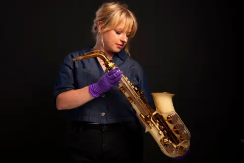 David Parry/PA Media Assignments A woman with blonde hair holds a saxophone
