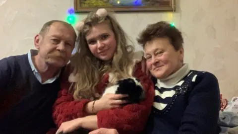 Anastasiia Timoshenko A girl with her grandparents