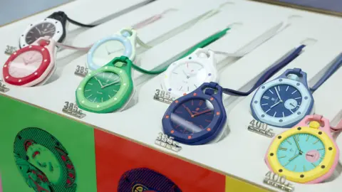 LightRocket via Getty Images An assortment of pocket watches in different colours lie on a stand