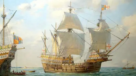 An artist's painting of the Mary Rose. It is a large, wooden ship with huge white sales and a St George's flaf flying at the front. The bow of another ship can be seen to the left of the Mary Rose. 