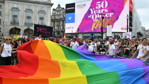 PA Media Celebrations during the 2019 Pride parade as the rainbow flag is carried through London's Piccadilly Circus