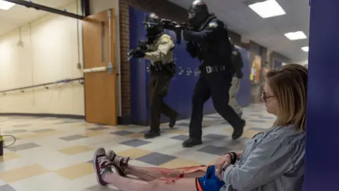 Getty Images A student with fake blood on their legs slumped on the floor during an active shooter drill in California