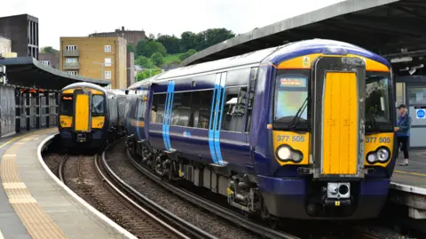 A blue Class 377 Southeastern train at a station.