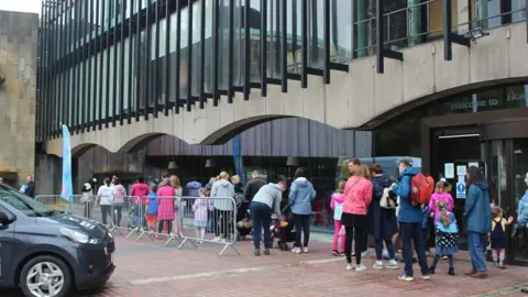 St Oswald's Hospice People queuing outside Newcastle Civic Centre