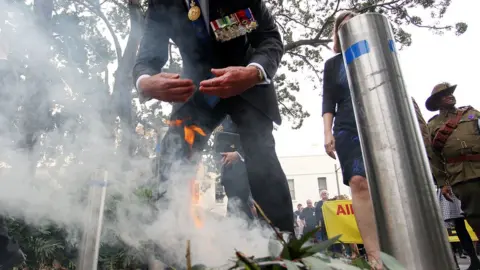 Getty Images A man partakes in a traditional smoke ceremony at an Anzac Day service in Sydney in 2017