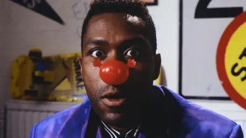 Getty Images Lenny Henry wearing his red nose in 1991