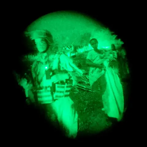 Hugh Kinsella Cunningham A mother and her child react as a peacekeeping unit walks through