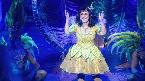 Lesley Joseph on stage as "the spirit of the beans"