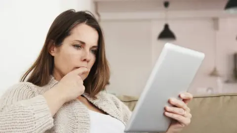 Getty Images Woman looking at tablet