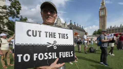 Getty Images Man outside Parliament with sign