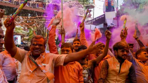 Getty Images BJP supporters celebrating in the western city of Pune