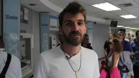 BBC Guillermo Olmo pictured reporting from a bank in Caracas