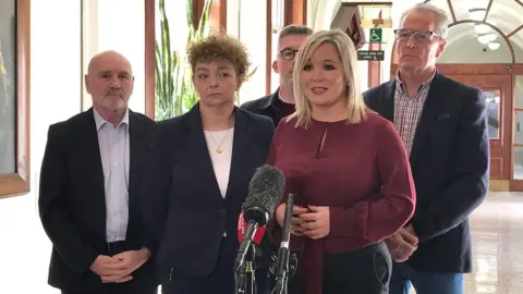 PA Media Michelle O'Neill with Sinn Féin colleagues at Belfast City Hall